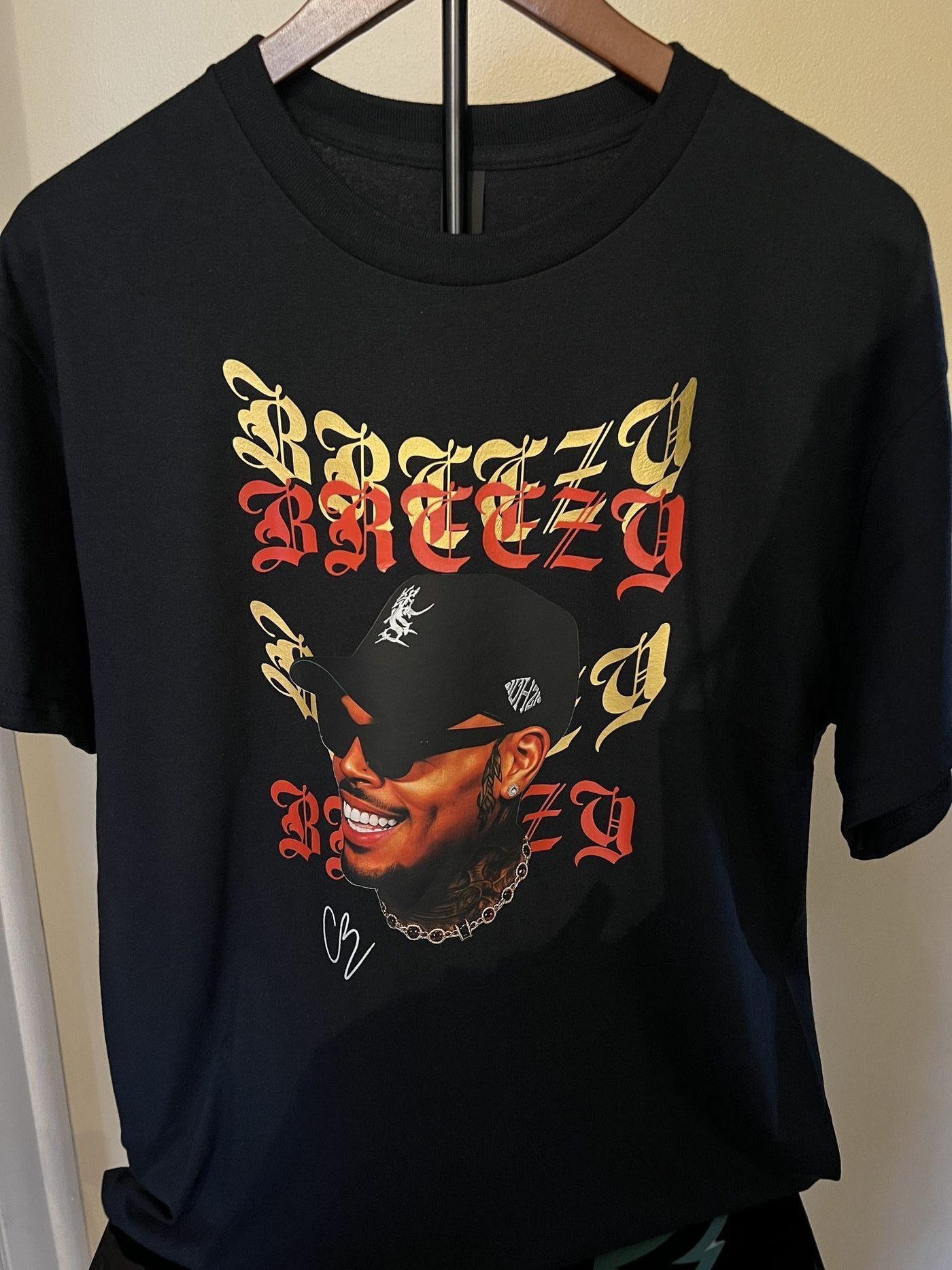 Custom black sweatshirt with rap artist portrait in gold and red lettering